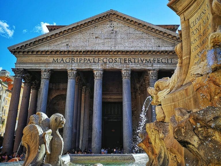 Frontal view of the pantheon rome witha fountain in the foreground