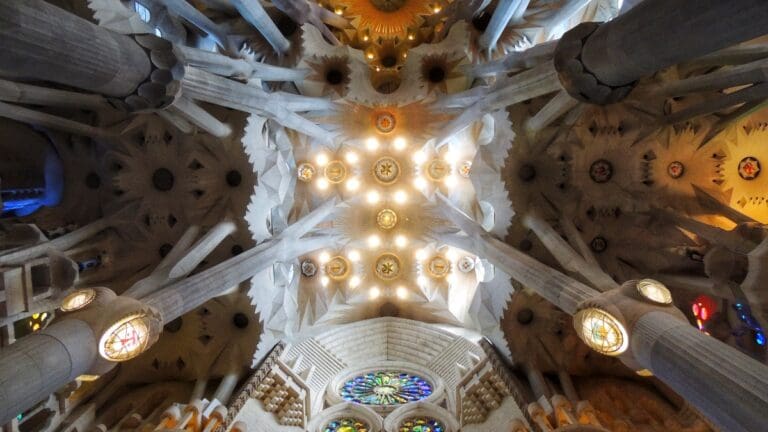 Cathedral ceiling with ornate columns and colorful stained glass light