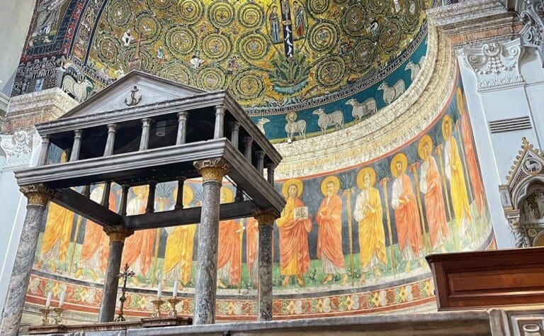 View of the golden apse mosaics of the Basilica of San Clemente with the baldacchino in the foreground