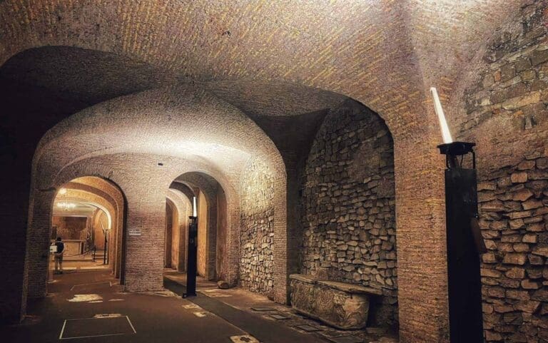 View of the Underground 4th century Basilica of san Clemente under the current church showing brick walls and arches dimly lit