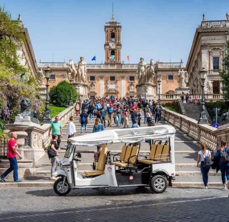 Through Eternity Tours Leading a Tuk Tuk Tour of Rome at the base of the Capitoline Hill