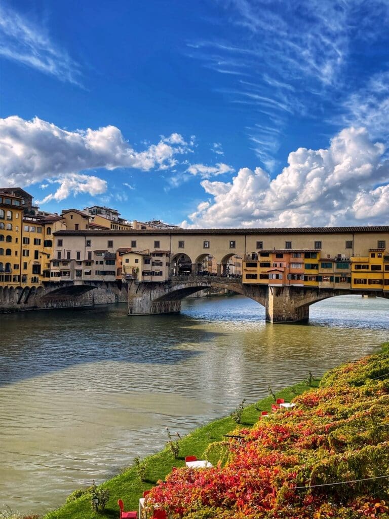 spring flowers wreathe the ponte vecchio in florence