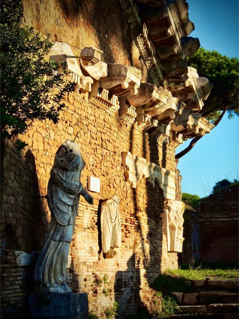 view of statues and ruins at ostia antica