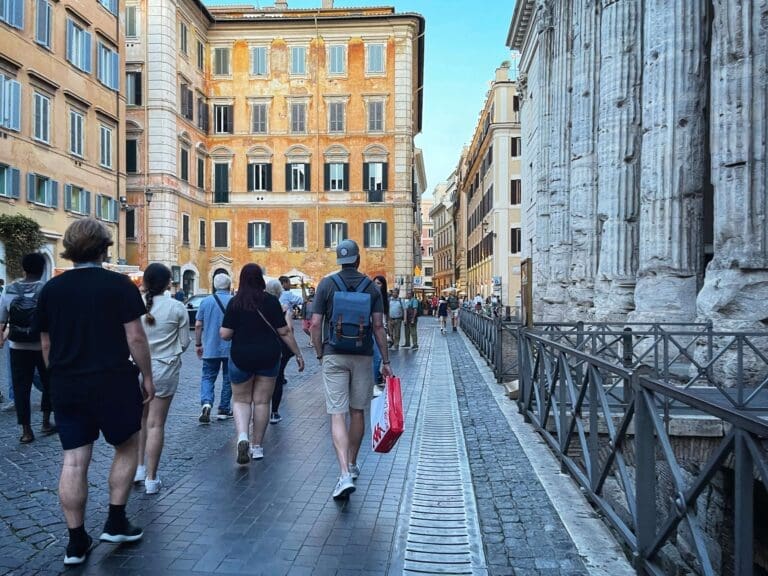a group passes though piazza di pietra in rome