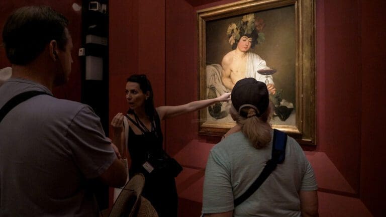 Florence Uffizi Guide Pointing at Artwork